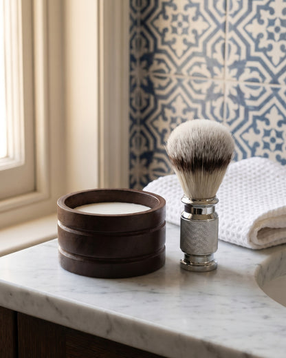 Kronos wooden shaving bowl, sandalwood soap and shaving brush in a bathroom