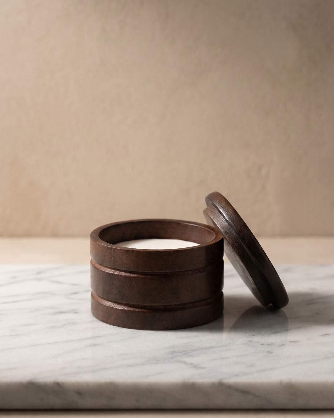Wooden bowl with sandalwood shaving soap, studio still