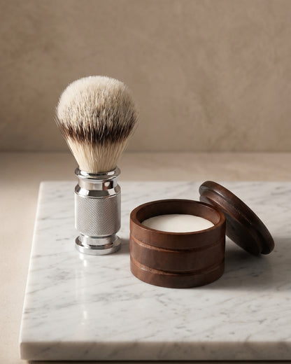Shaving brush beside a wooden bowl of sandalwood soap