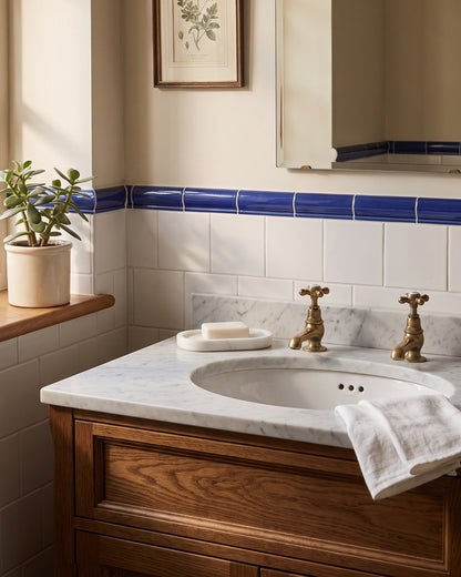 Kronos marble storage tray on a marble washstand in a traditional British bathroom