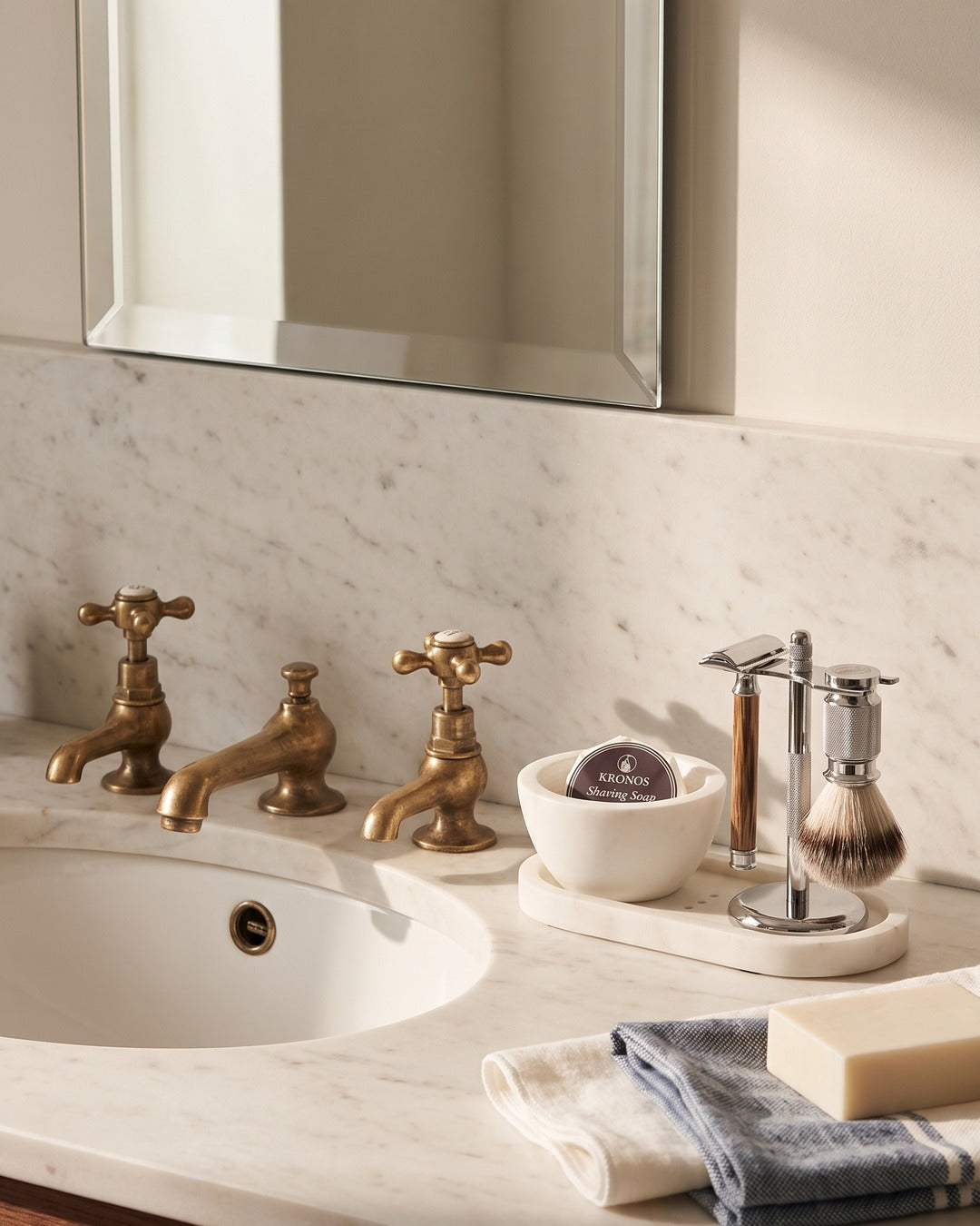 The Kronos Marble Suite Set arranged on a marble washstand in a traditional British bathroom