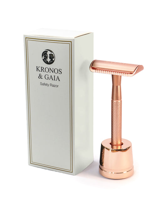 Rose gold safety razor on its stand beside the Kronos & Gaia box